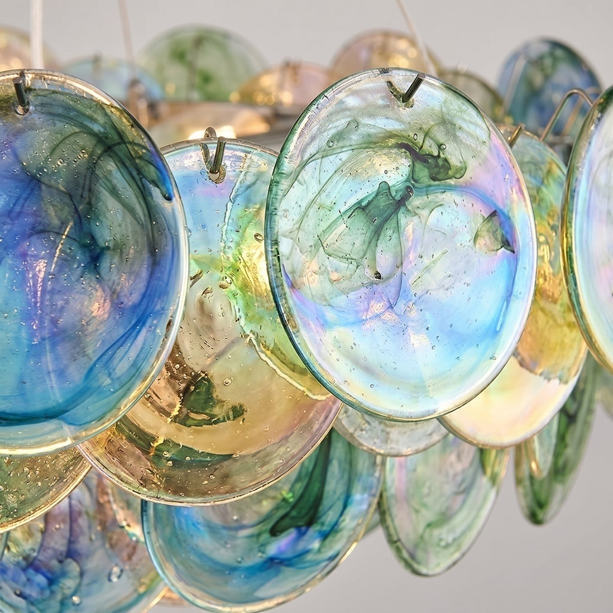 Installation du lustre en verre irisé, montrant la plaque de fixation au plafond et le câble de suspension ajustable.