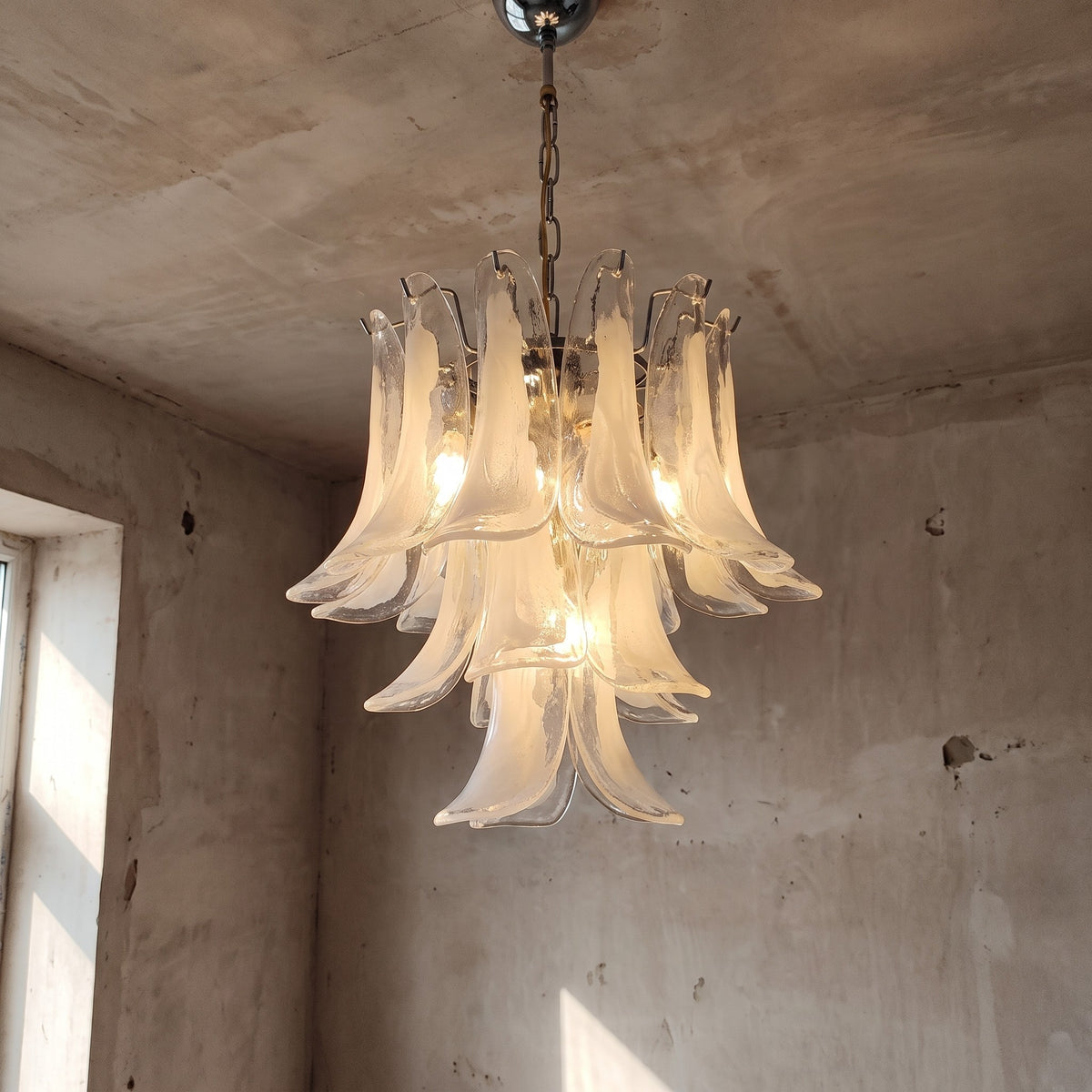 Lustre style Murano en verre blanc opalin, forme de fleur, suspendu dans un salon moderne, éclairage doux et élégant.